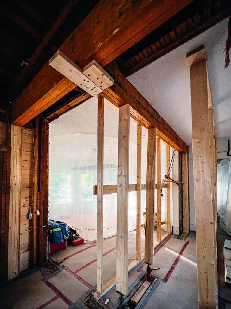 Taking down a load-bearing wall in a house and adding temporary support walls.