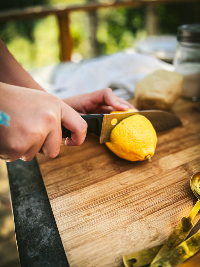Slicing a lemon in half.