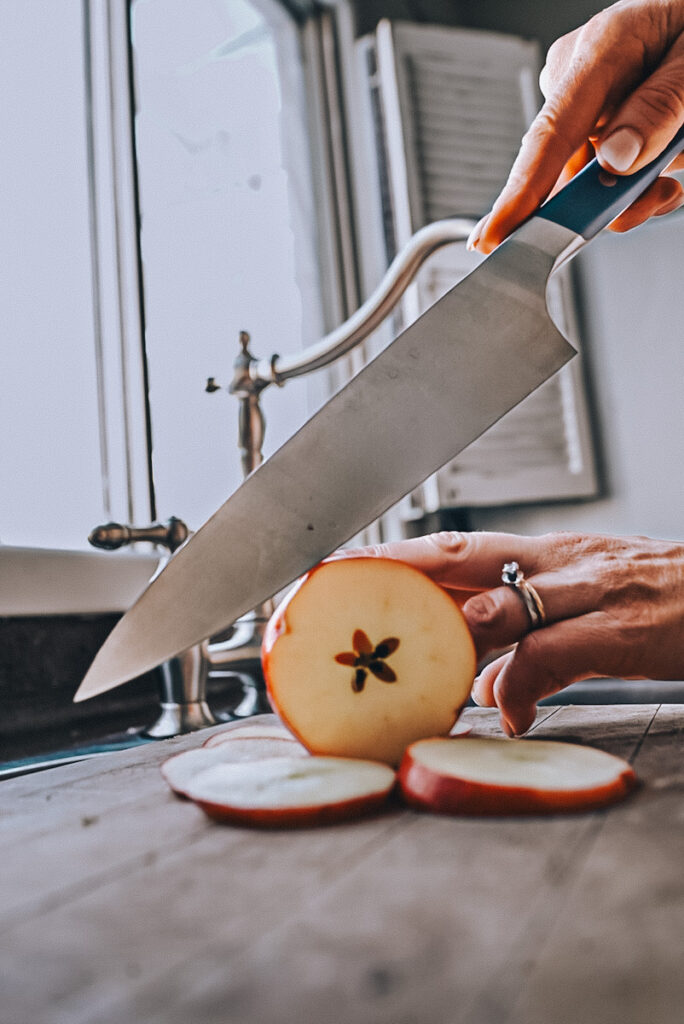 Cutting apple slices to make hot apple cider.