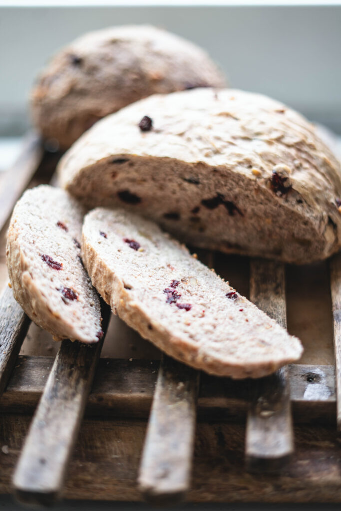 Cranberry walnut bread that is sliced and ready to eat.