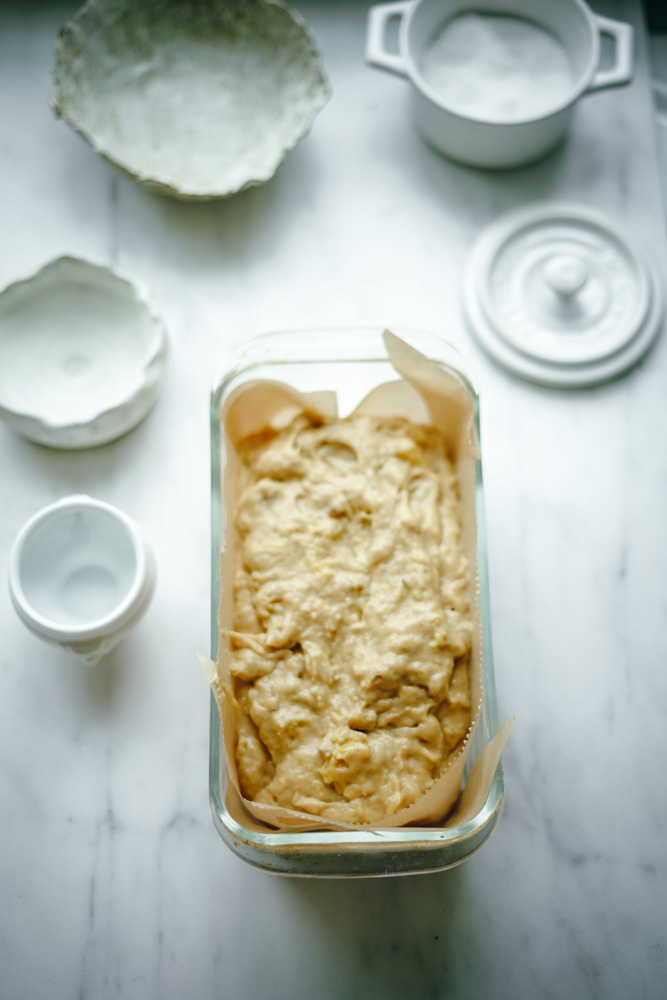 Bread baking pan full of pineapple bread batter ready to be baked.