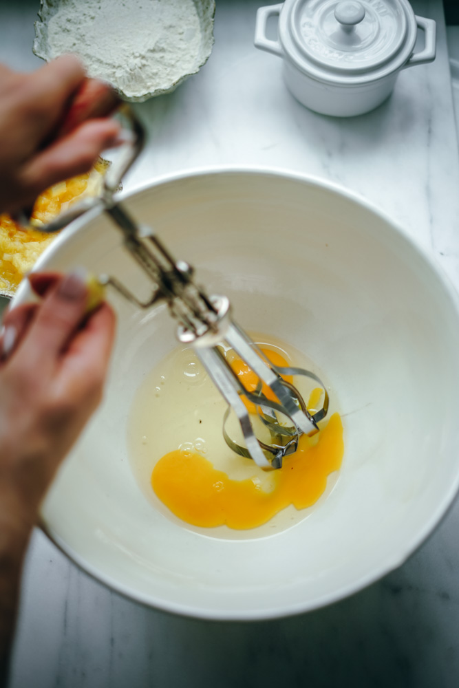 Beating the eggs to make pineapple bread.