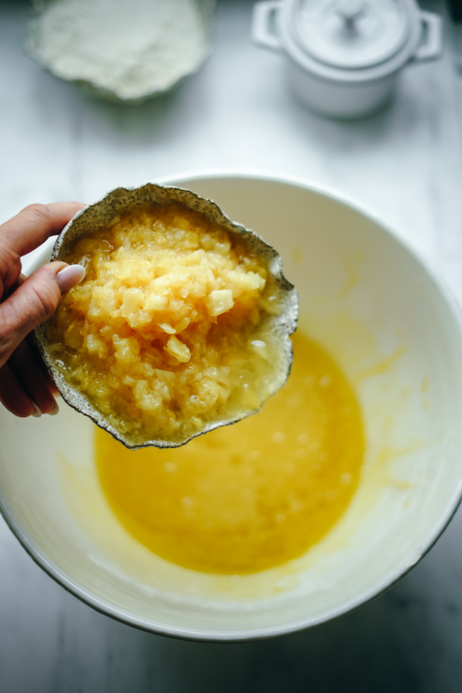 Adding pineapple to make a bread batter.