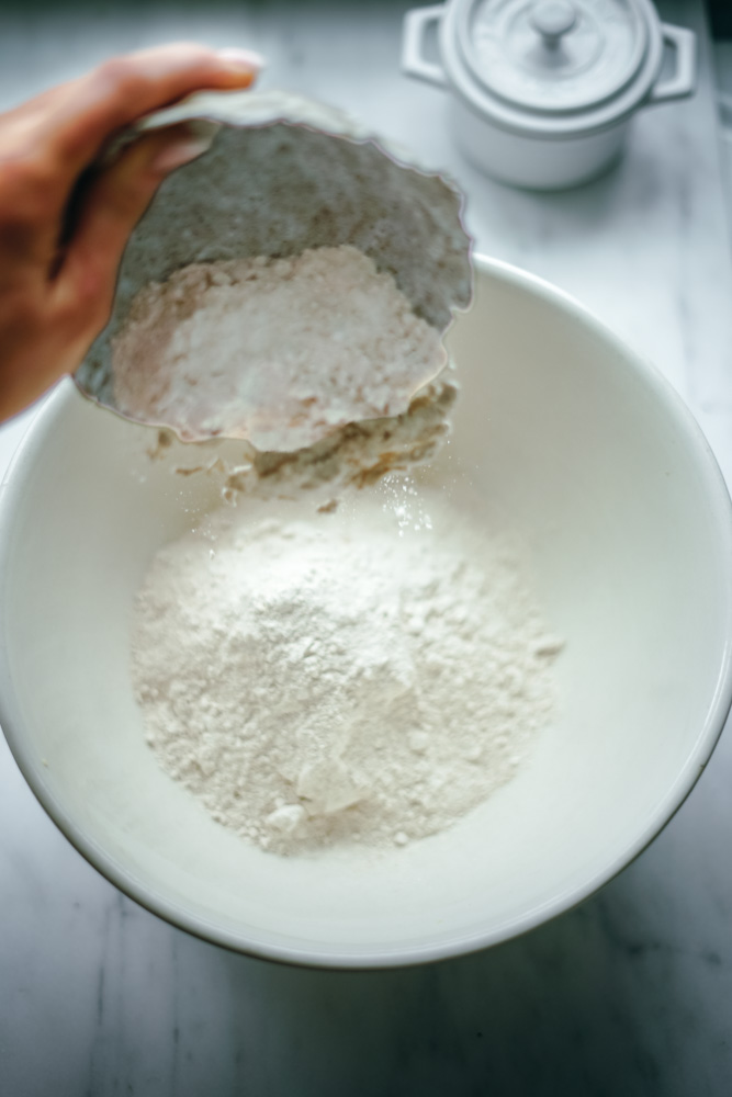 Adding all-purpose flour to make bread.