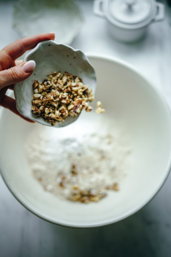 Walnuts going into the batter for a loaf of pineapple bread.