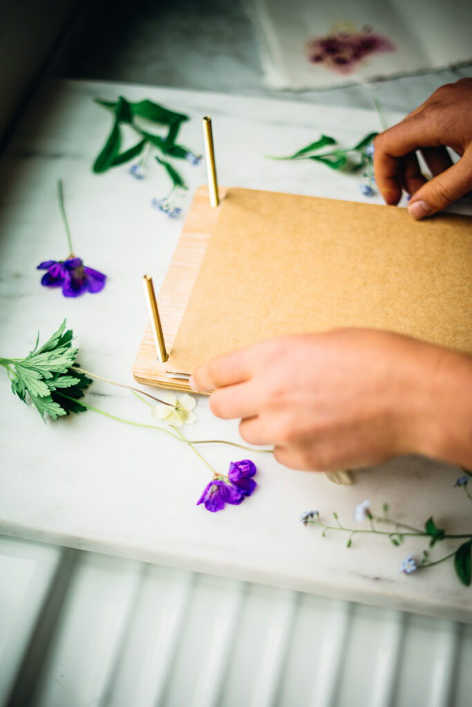 Securing the flower press to preserve them.