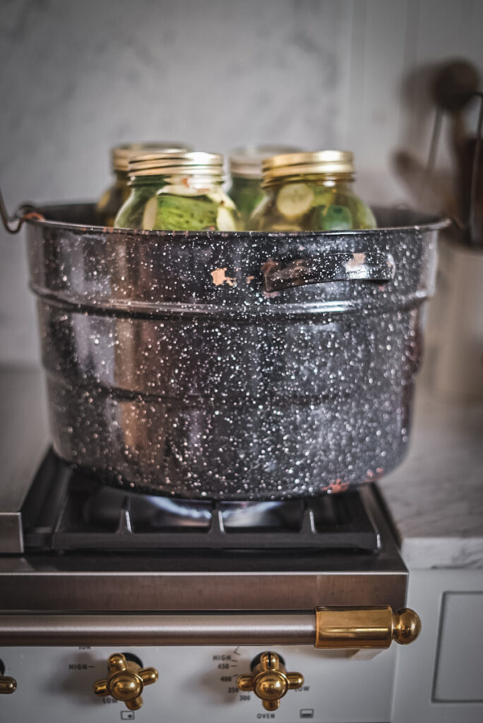 Canning dill pickles in a water bath.
