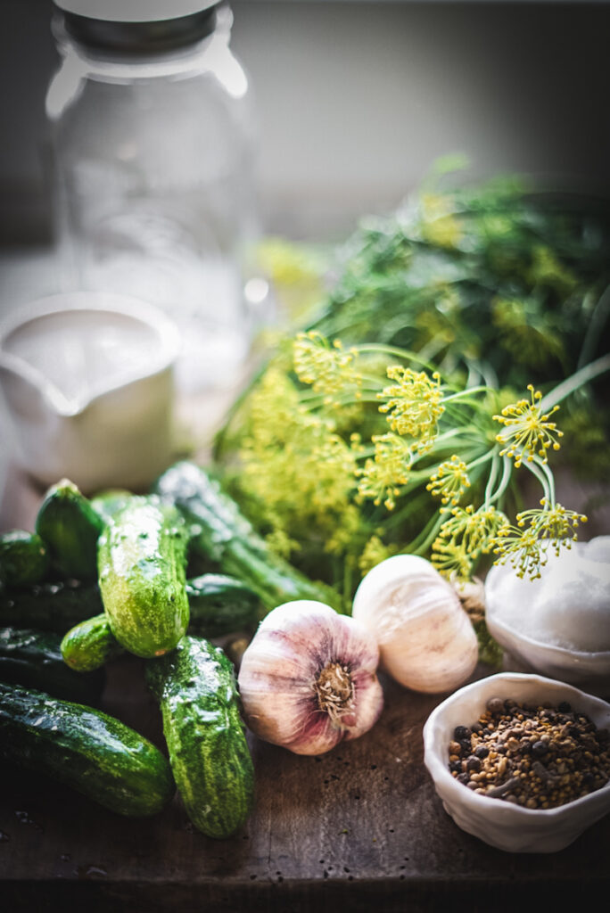 Dill, garlic, pickling spice, cucumbers and all ingredients for making dill pickles.
