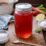 Large mason jar full of rhubarb syrup that's been homemade