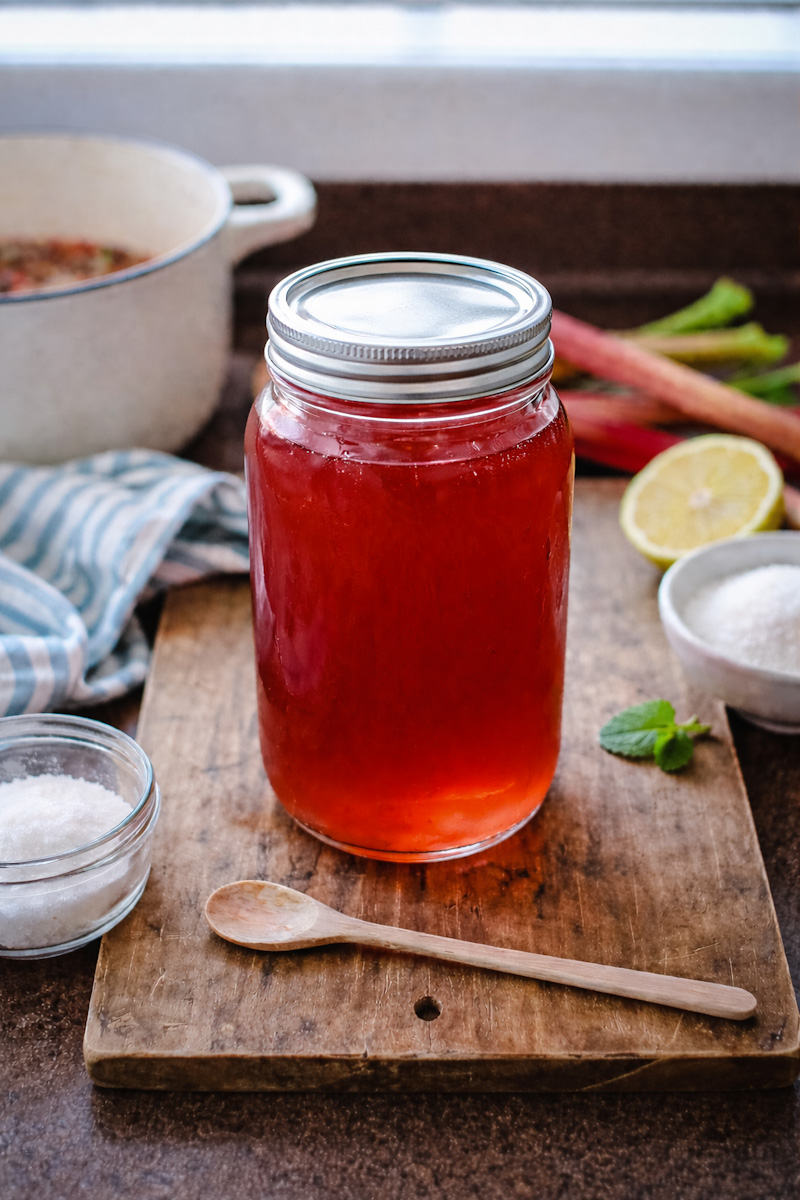 Large mason jar full of rhubarb syrup that's been homemade