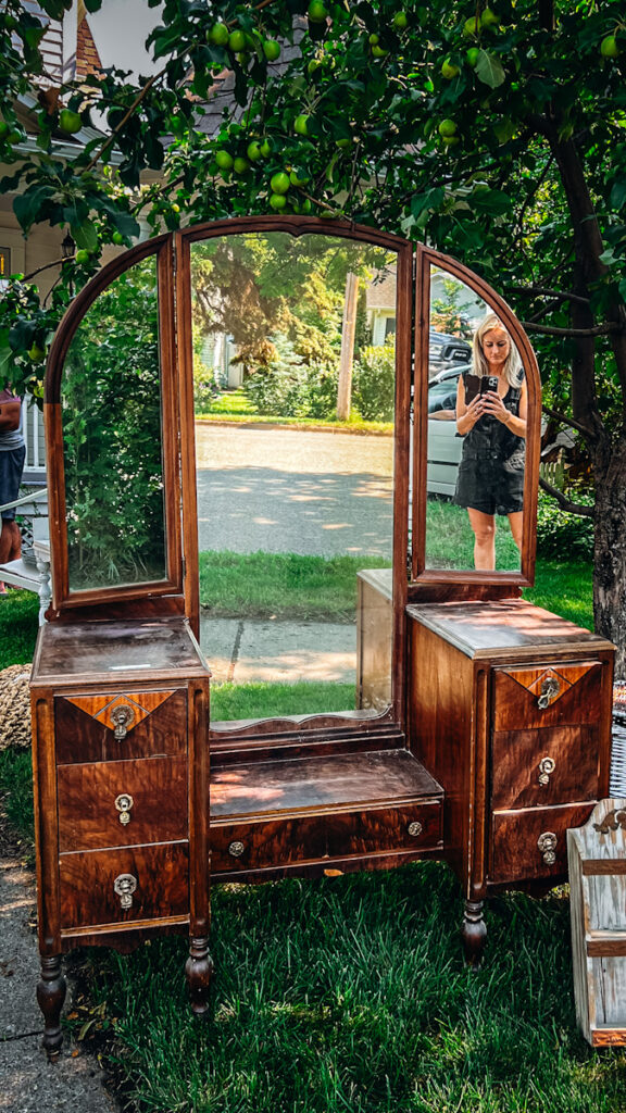Beautiful vintage dresser that is dark wood with a large mirror vanity.