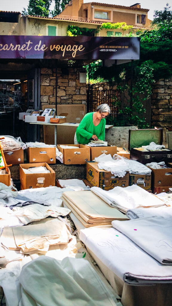 A large amount of French vintage linen at a market in Provence. 