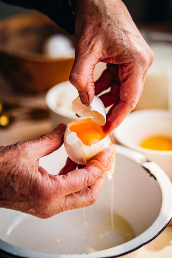 Separating an egg to make into a large bowl.