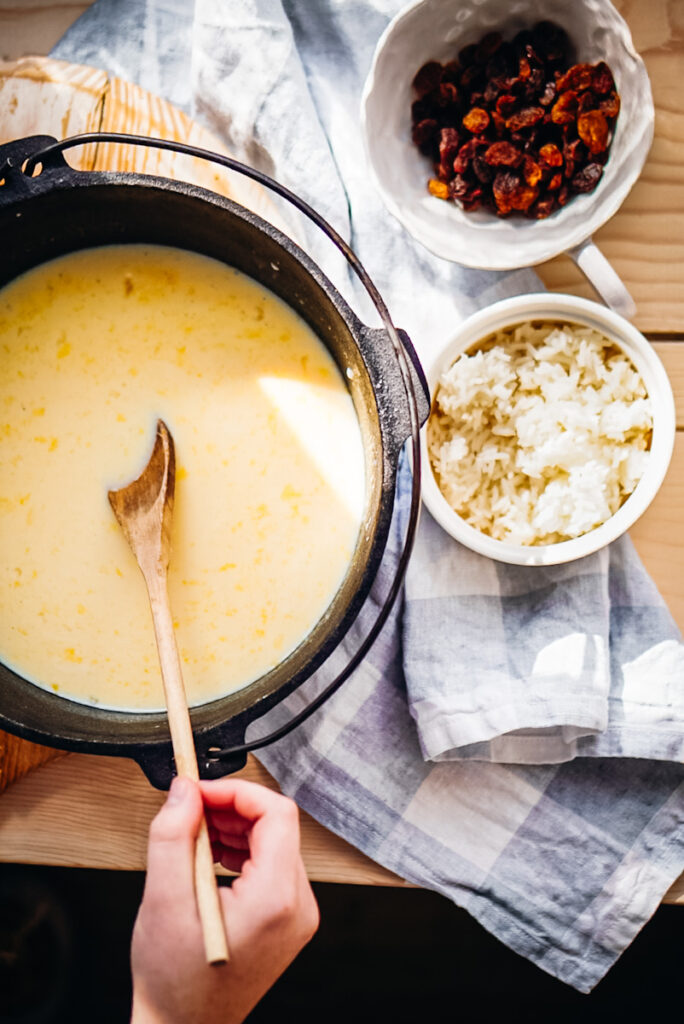 Making baked rice pudding with raisins, nuts, and egg mixture.