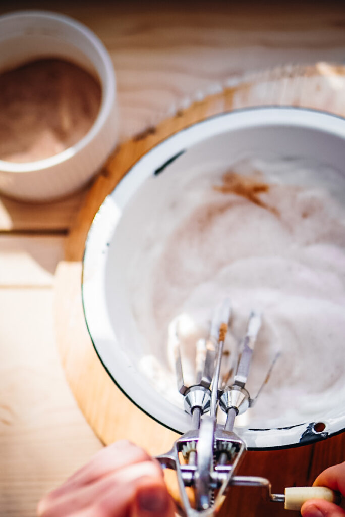 Whisking meringue with cinnamon to top baked rice pudding.