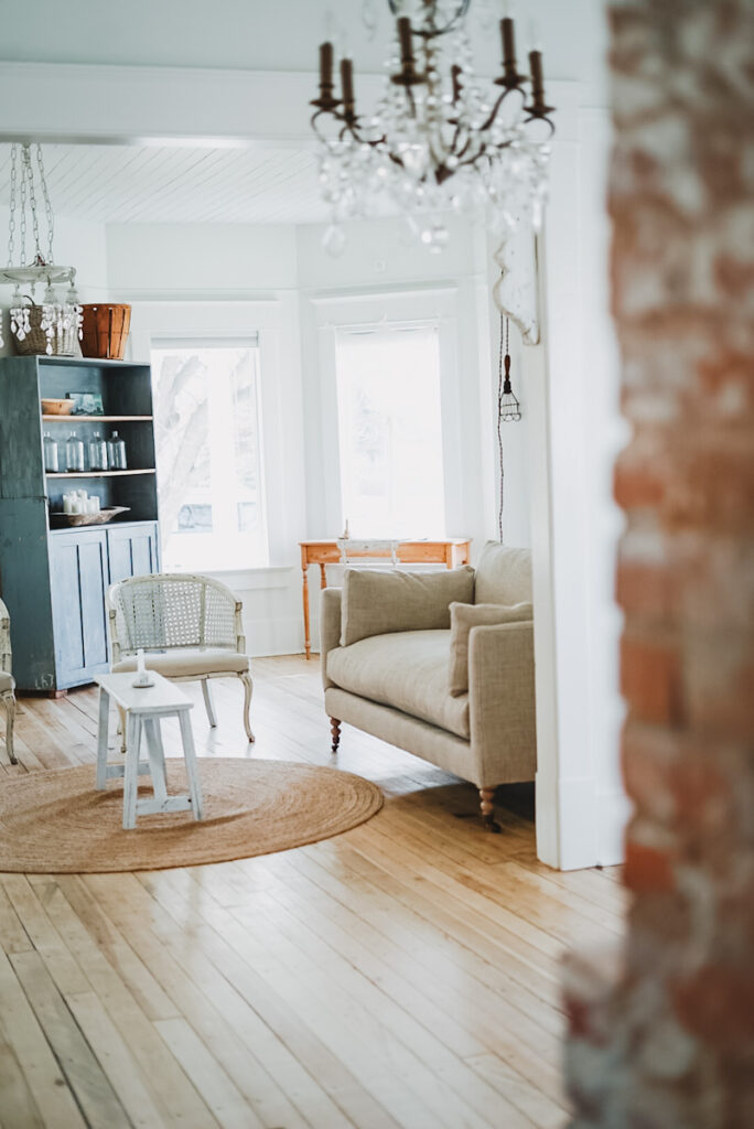 Very calm, beautiful living room area with a sofa and antique chairs.
