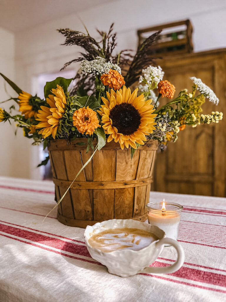 Beautiful bouquet of fall and late summer flowers in an apple basket with sunflowers.